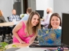 Commercial Photography Two Ladies In Office Smiling At Laptop