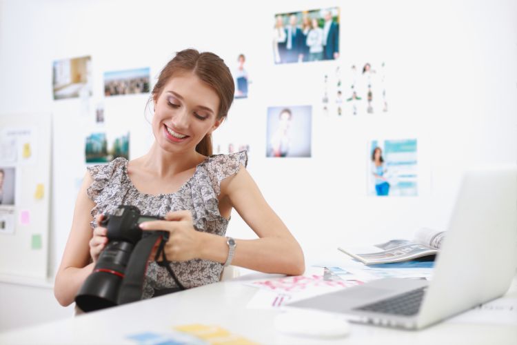 Young woman photographer processing pictures