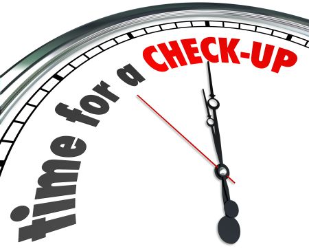Time for a Check-Up words on a clock face as a reminder to get a physical, examination or evaluation as a preventative precaution and good health care